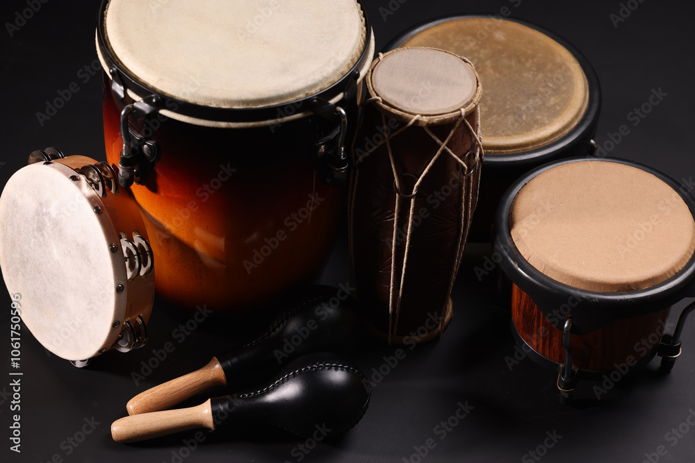 Obraz premium Different drums on a black background, percussion musical instruments