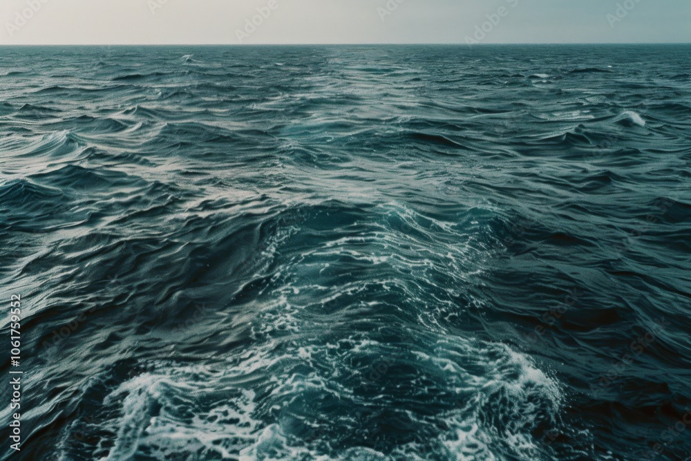 Fototapeta premium Endless waves create a vast, undulating pattern on the open ocean, evoking a sense of adventure and infinite possibility.