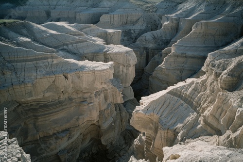 Dramatic canyon landscape with stratified rock formations, showcasing nature's raw power and ancient beauty in a sunlit desert setting. photo