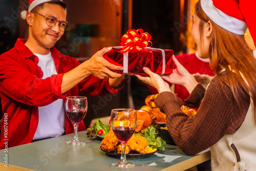 An upbeat New Year’s Eve celebration with Asian friends, family, colleagues, blending work and holiday vibes.while table brims with champagne, wine, gift boxes, delicious foods grilled chicken