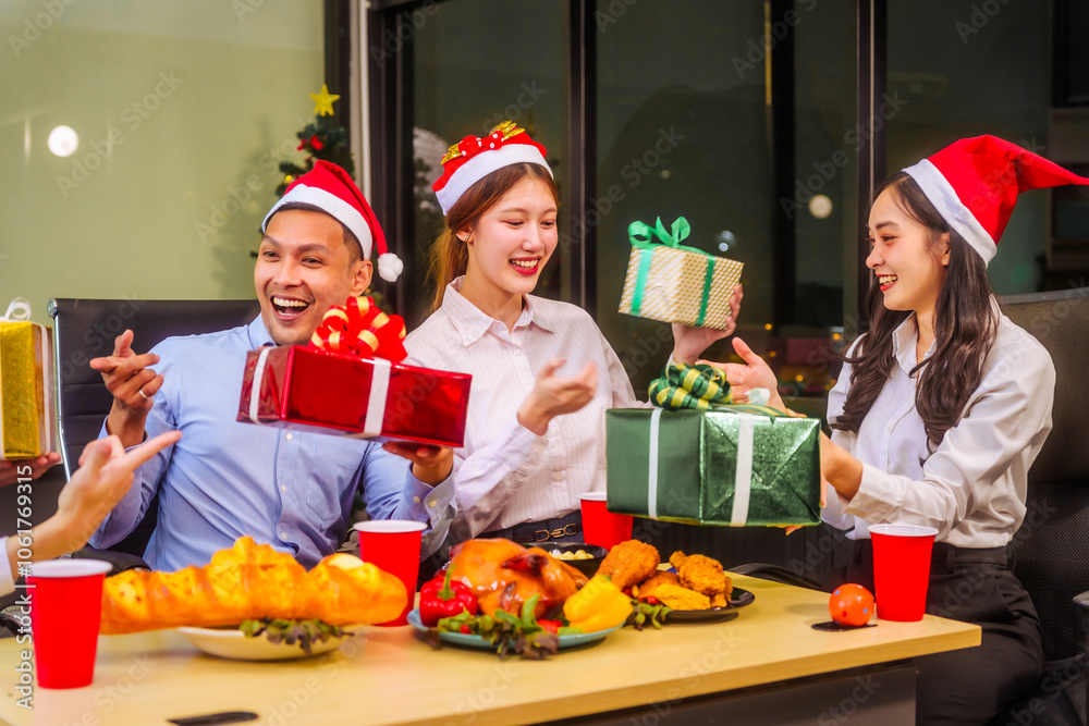 A festive office Christmas party with friends and colleagues celebrating after work. Asian business people wear Santa hats, enjoy grilled chicken, drinks, and gifts, indoor with holiday lights.