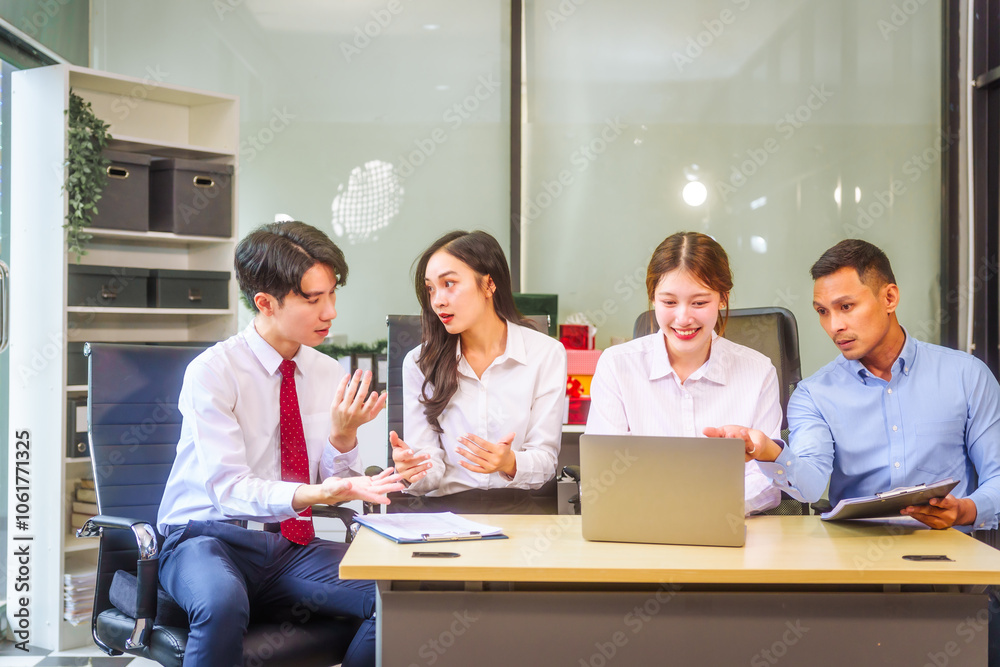 In a professional office setting, two men and two women, boss and subordinates, celebrate reaching business target. They sit together, smiling, laptops and desks, sharing success and congratulations. In a professional office setting, two men and two women, boss and subordinates, celebrate reaching business target. They sit together, smiling, laptops and desks, sharing success and congratulations.