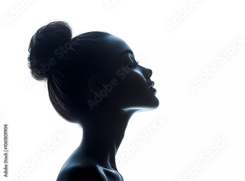 Silhouette of a beautiful woman with a hair bun, side view, isolated on a white background.