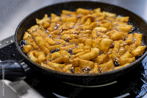 The dough is fried in pieces in a pan in oil (Pa Thong Ko), Baursaks or chak chak is a traditional national dish. photo