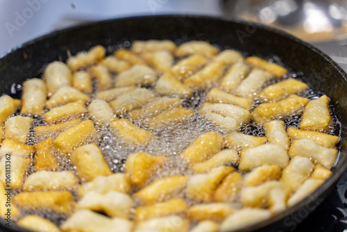 The dough is fried in pieces in a pan in oil (Pa Thong Ko), Baursaks or chak chak is a traditional national dish. photo