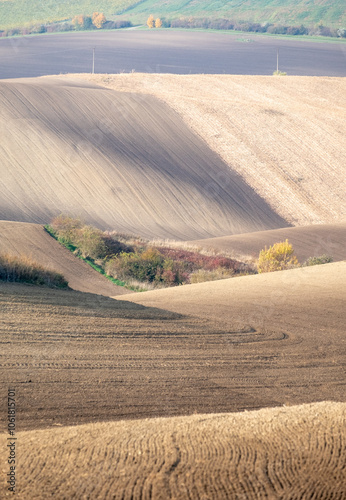 Stunning undulating arable agricultural landscape, photographed in autumn in south Moravia in the Czech Republic. The area is known as Moravian Tuscany and is full of rolling hills used for farming. photo