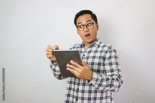 Surprised young Asian man wearing a white checkered shirt reading inbox email isolated on white background. People Lifestyle Concept.