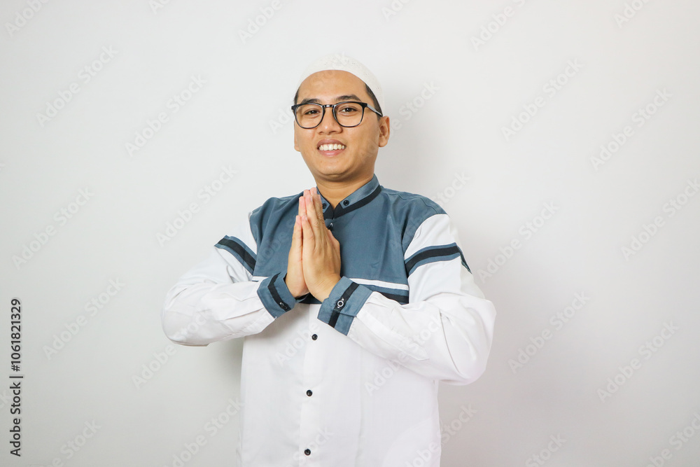 Moslem Asian man smiling to give greeting during Ramadan celebration Moslem Asian man smiling to give greeting during Ramadan celebration