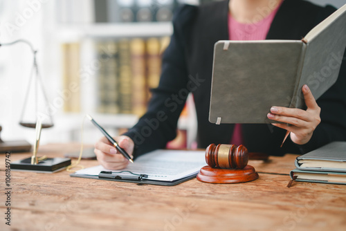 Εκτύπωση καμβά A lawyer working in a law office, reviewing documents and making notes, with a gavel and scales of justice on the desk