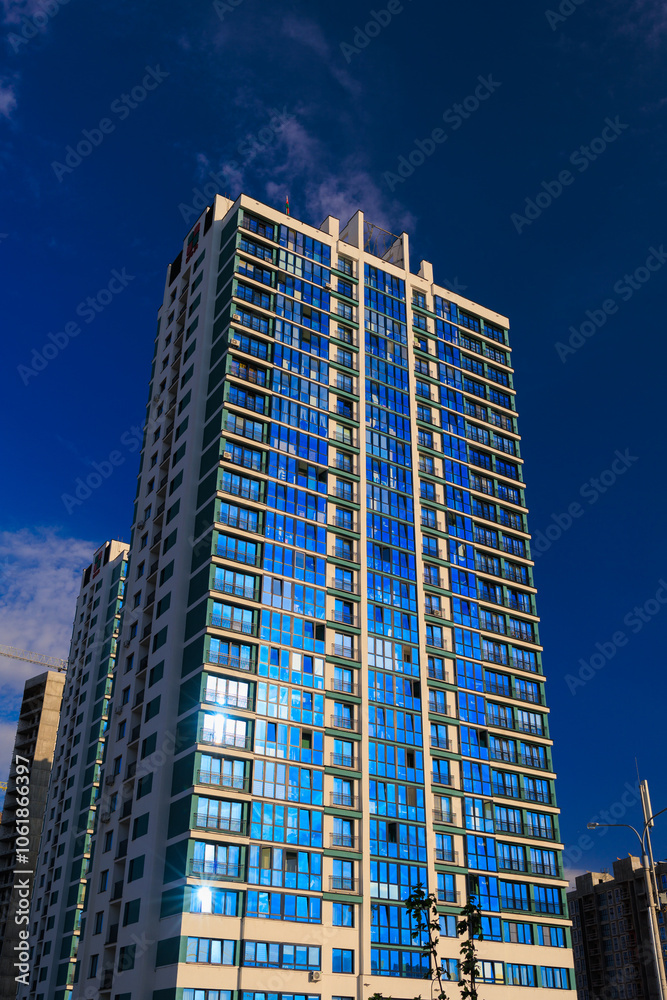 Obraz premium Modern buildings, walls and windows. City view on a sunny day. 