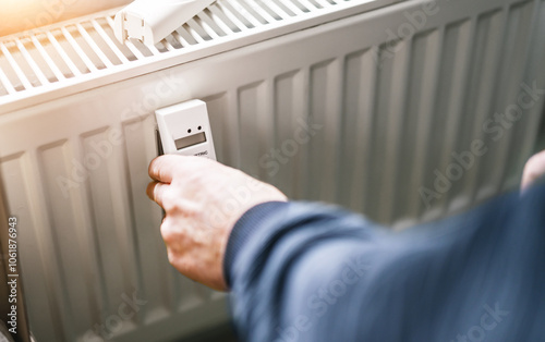 Obraz na płótnie heating system engineer ist adjusting the digital w-lan network thermometer reader on a new thermal radiator. w salonie