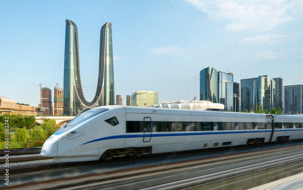 Naklejka premium High-speed rail speeds on Bridges and the modern city skyline of hangzhou, China