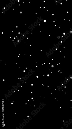 Seamless loop animation of simple snowflakes slowly falling down. Soft round snowflakes in different sizes creating depth. Trendy blurry surface. Vertical video in minimalist style isolated on black