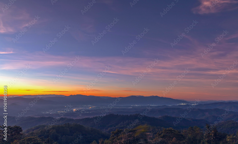 Sunset sky with mountains, Predawn clear sky with orange horizon and blue atmosphere. Smooth orange blue gradient of dawn sky. Sunset sky with mountains, Predawn clear sky with orange horizon and blue atmosphere. Smooth orange blue gradient of dawn sky.