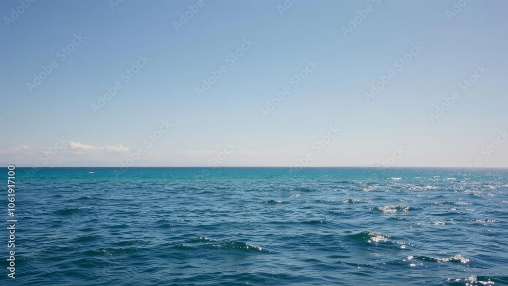 Deep blue ocean with clear skies, showing a pristine beach, peaceful, calm Deep blue ocean with clear skies, showing a pristine beach, peaceful, calm