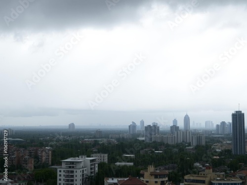 Wallpaper Mural Dark storm clouds looming over a city skyline, with rain pouring down, pouring, urban Torontodigital.ca