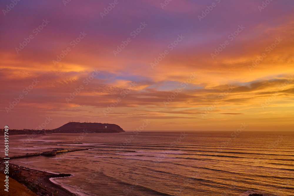 Fototapeta premium Breathtaking sunset views over La Costa Verde From Miraflores, it’s pure magic watching the cliffs meet the Pacific, waves crashing below, and endless skies above. 