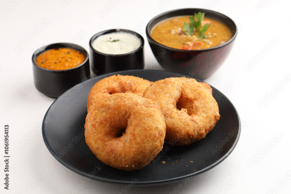 Traditional breakfast of South India IDLY VADA served with sambar Chutney in a ceramic plate Traditional breakfast of South India IDLY VADA served with sambar Chutney in a ceramic plate