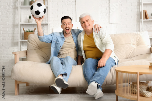 Mature man with his son wat...