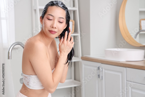 Young Asian woman applying ...