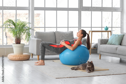 Young woman exercising with...