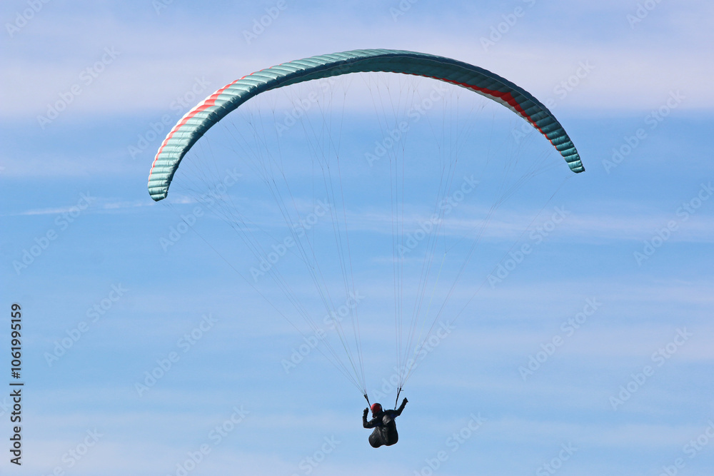 Paraglider flying in a blue sky Paraglider flying in a blue sky