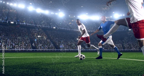 Football player is dribbling the ball down the field and kicks the ball towards the goal while other players trying to interfere. Professional stadium with animated crowd.