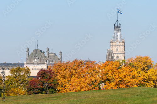 The tower of the Quebec parliament with in foreground the battlefields park of the plains of Abraham and colorful autumn trees (Québec city, Québec, Canada)