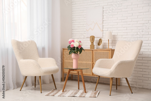 Vase with beautiful dahlia flowers on table in living room