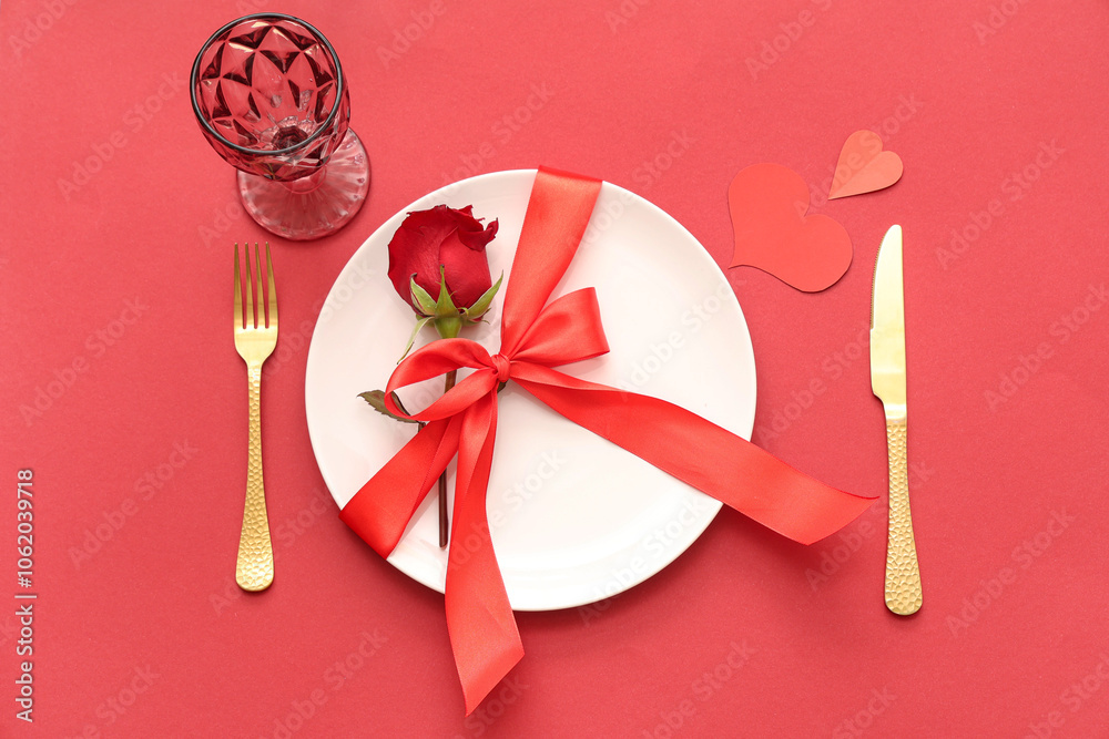 Beautiful table setting with red rose and paper hearts on color background. Valentine's Day celebration Beautiful table setting with red rose and paper hearts on color background. Valentine's Day celebration