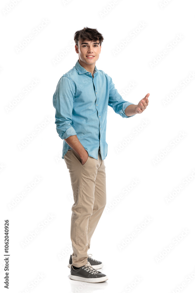 happy casual man standing in line and making a hand gesture happy casual man standing in line and making a hand gesture