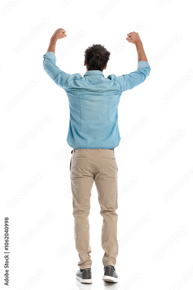 attractive young student seen from behind with arms above head