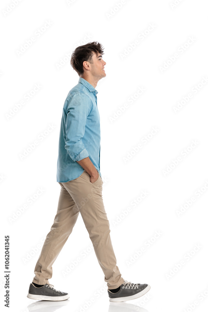 proud young student walking with hands in pockets and smiling proud young student walking with hands in pockets and smiling