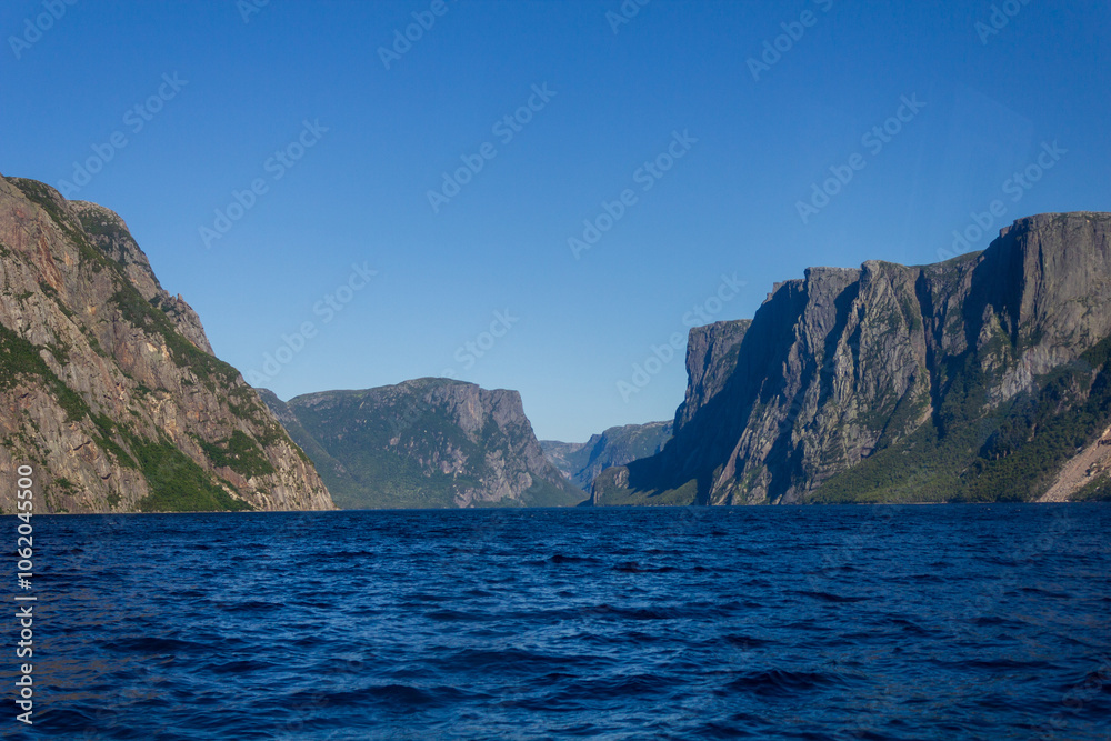 Scenic Fjord Landscape with Majestic Mountains and Calm Waters Scenic Fjord Landscape with Majestic Mountains and Calm Waters