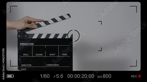 Movie slate or clapperboard hitting with recording frame. Close up hand holding empty film slate and clapping in front of camera clear background. Open and close film slate filming a video production