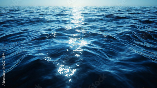 Calm ocean surface reflecting sunlight at dawn