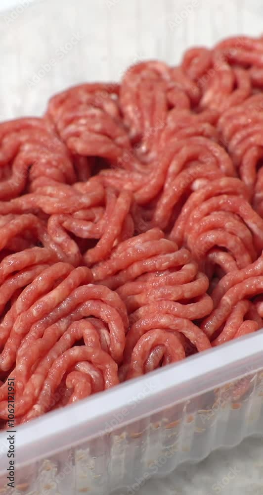 Minced meat, beef mince, forcemeat, fresh raw uncooked ground meat close up, rotating background. Vertical video content for social networks Minced meat, beef mince, forcemeat, fresh raw uncooked ground meat close up, rotating background. Vertical video content for social networks