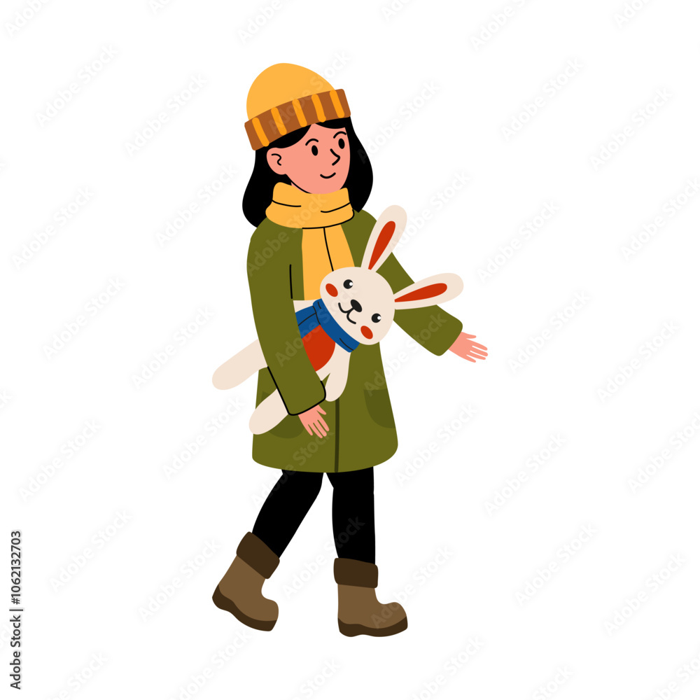 A girl in a warm coat walks outside holding a stuffed bunny on a chilly day in winter A girl in a warm coat walks outside holding a stuffed bunny on a chilly day in winter