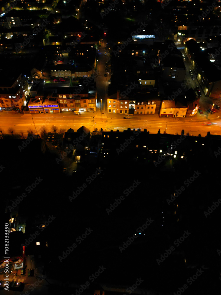 Fototapeta premium Aerial View of Illuminated Central Cambridge City of Cambridgeshire of England UK During Night. High Angle Footage Was Captured with Drone's Camera at Just After Sunset on March 22nd, 2024