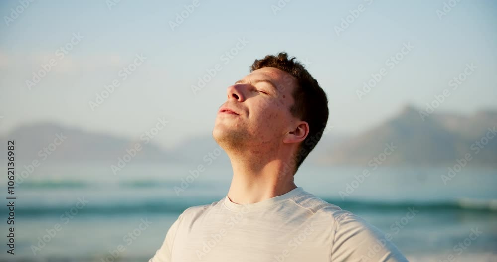 Man, relax and breathing with fitness on beach for peace, health and wellness by sea in nature. Young, male person or athlete with smile for natural fresh air, breeze or mindfulness on ocean coast