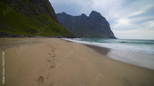 Walking Along Mountain Beach Following Footprints