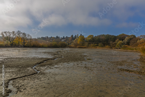 A drained pond and mud on its bottom photo