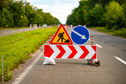 Road signs indicating construction work ahead, alerting drivers to detours and safety measures. Ideal for illustrating traffic management, urban development, or infrastructure projects. A vital image 