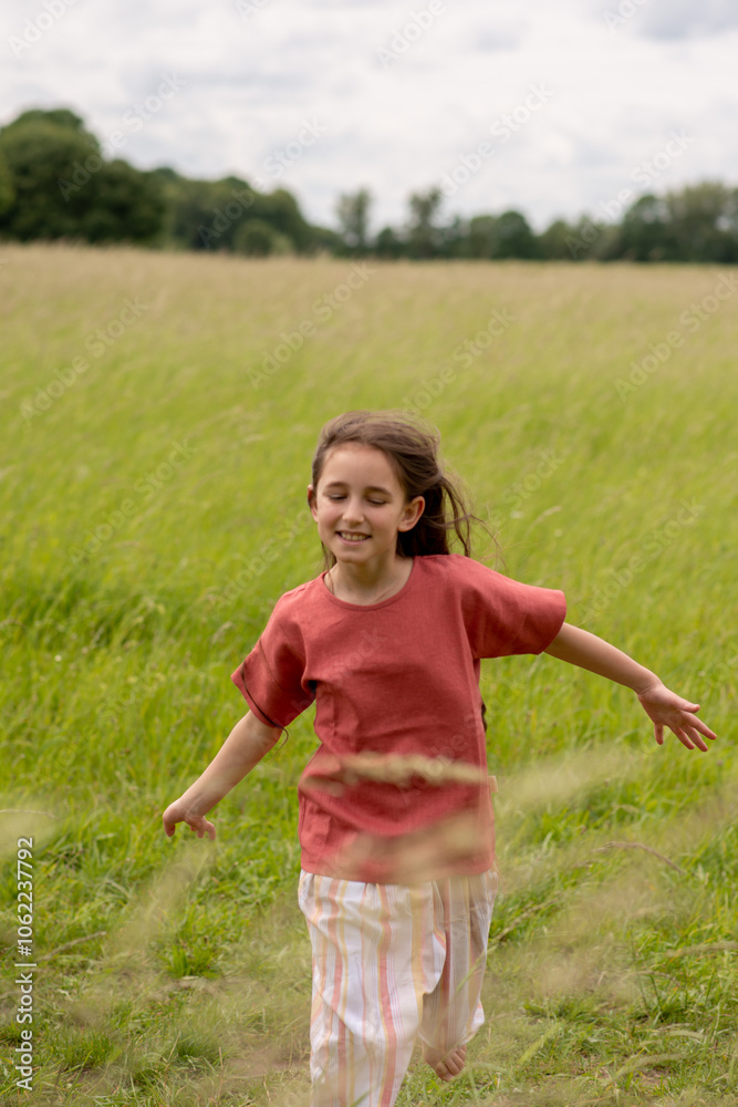 A little girl runs across the field. freedom concept A little girl runs across the field. freedom concept