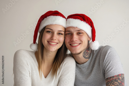 Joyful couple celebrating Christmas with festive hats in a cheerful indoor setting