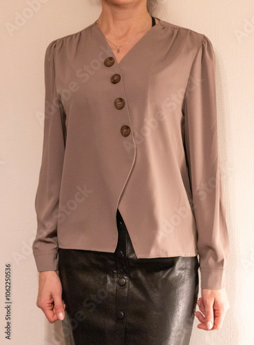 Skinny woman wearing stylish leather tight skirt and warm tone blouse. Fashion