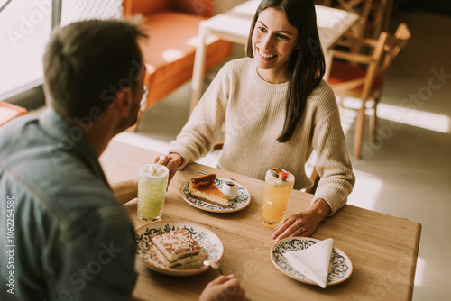 A joyful couple enjoys coff...