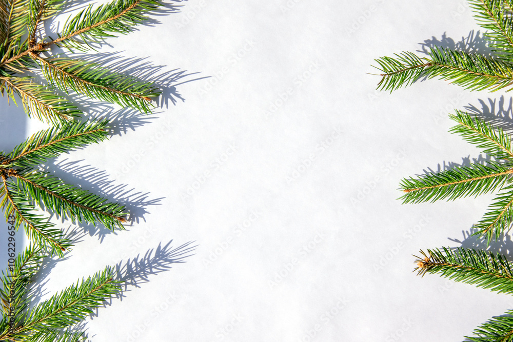 Green pine branches frame a blank white background in a winter setting, ideal for holiday-themed crafts and decorations Green pine branches frame a blank white background in a winter setting, ideal for holiday-themed crafts and decorations
