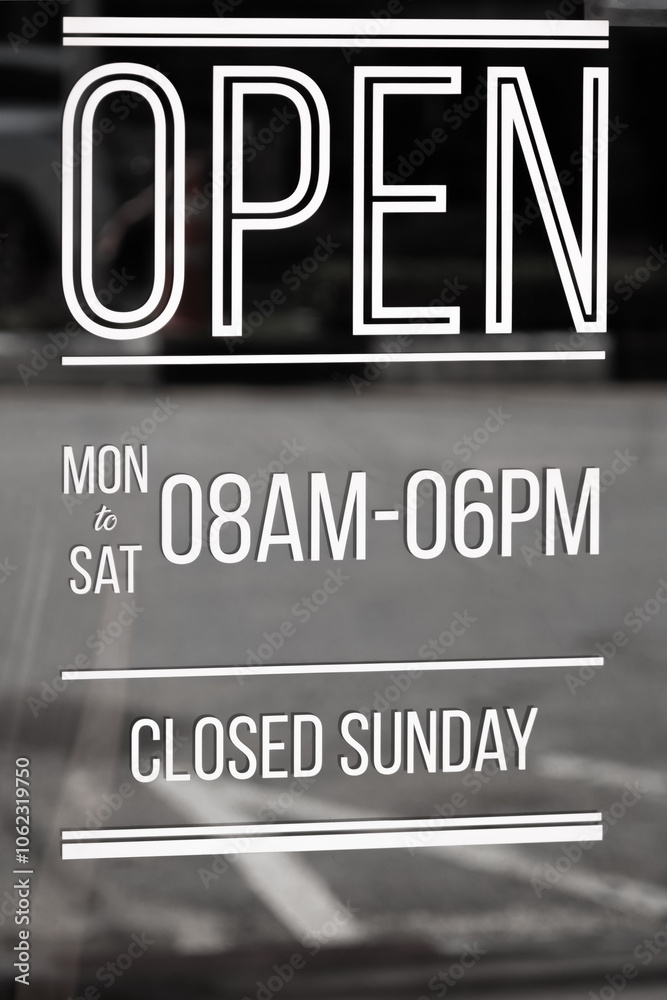 Sign showing business opening hours. Business hours sign on the glass door of a shop Sign showing business opening hours. Business hours sign on the glass door of a shop