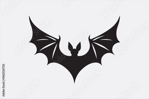 A black silhouette of a flying bat with outstretched wings.